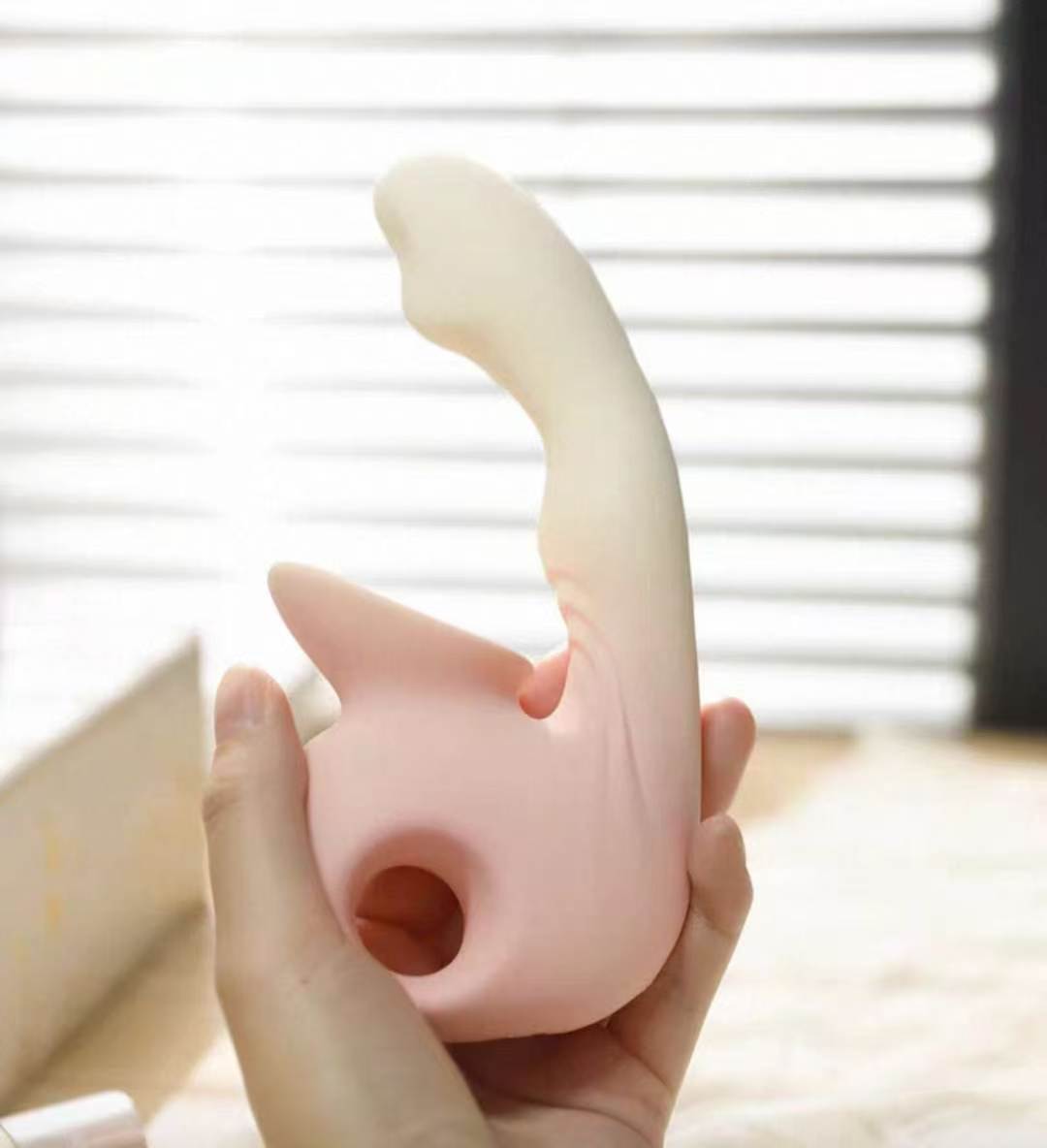 Rhapsody Pro held in hand showing finger-loop handle and overall size